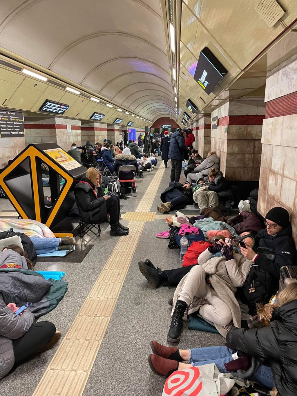 People taking shelter in an underground subway tunnel