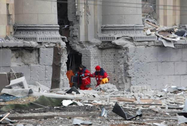 Rescuers dig through rubble after shelling of the state office in Kharkiv