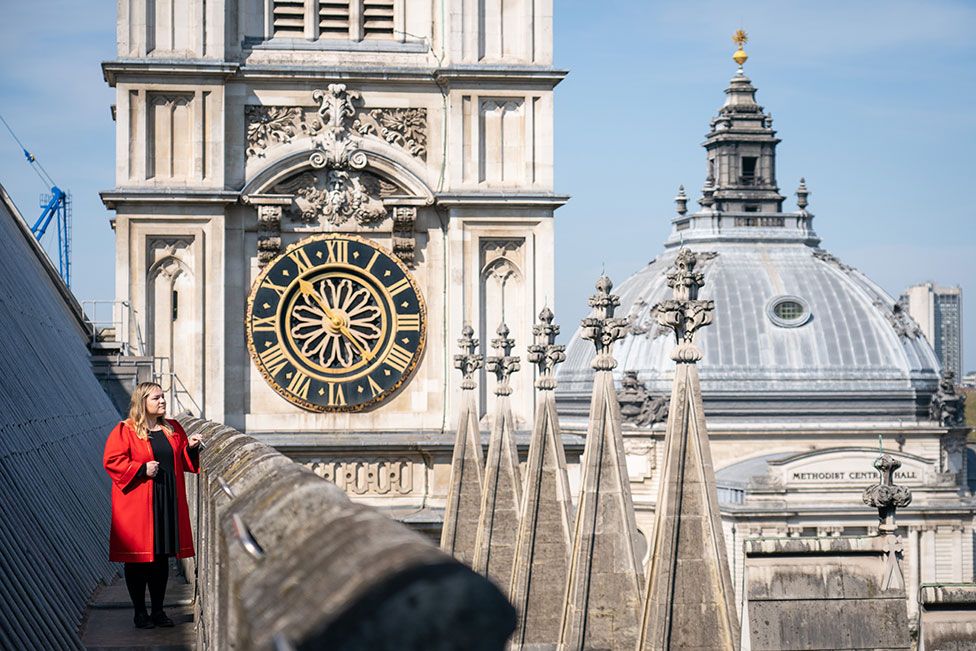 Leticia Edwards, Westminster Abbey Marshall, looks out from the main nave roof, near the Hawksmoor Towers of Westminster Abbey, in central London, on 20 April 2022