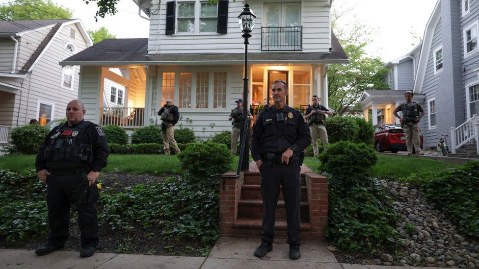 Police stand outside the home of U.S. Associate Justice Brett Kavanaugh as abortion-rights advocates protest on May 11, 2022 in Chevy Chase, Maryland