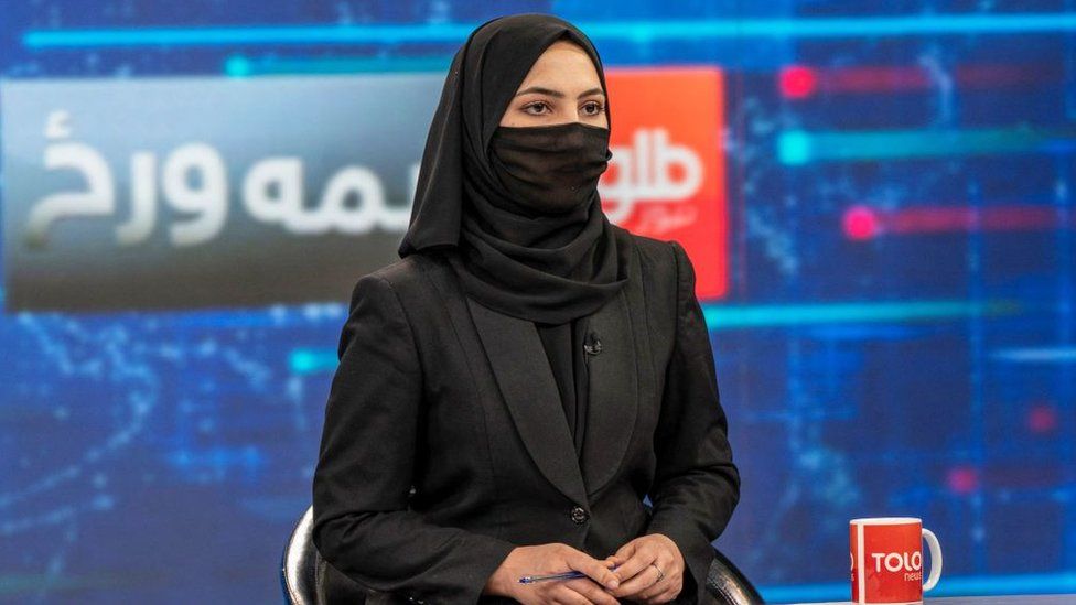 Tolo News presenter Sonia Niazi covers her face during a broadcast