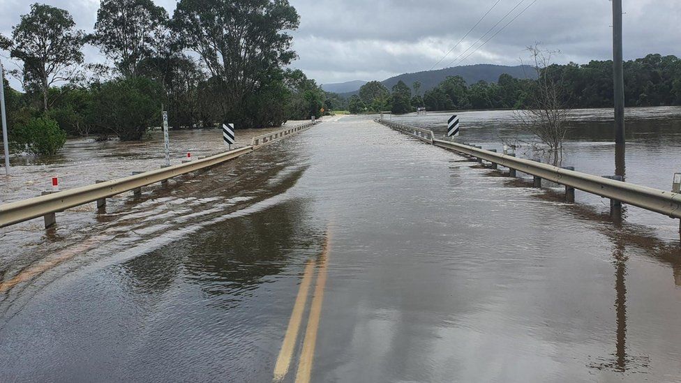 Flood water covers a bridge in Woodford, Queensland